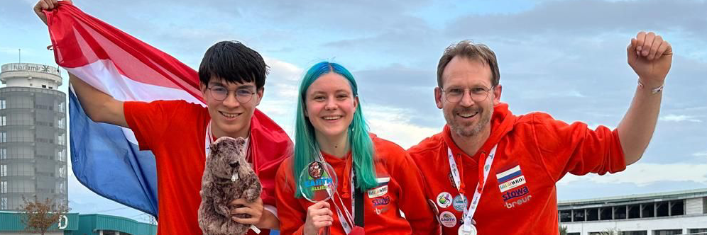 Co-founders standing with medals
